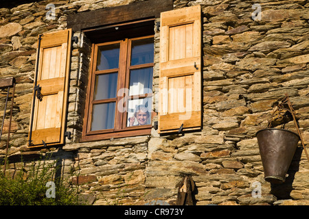 Girl at the window of a farm near Vale, Cevennes, France, Europe Stock Photo