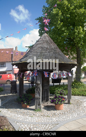 Village water pump Woolpit, Suffolk, England June 2012 diamond Jubilee flags bunting Stock Photo