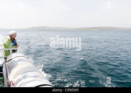 The Tingwall Rousay Ferry, Orkney Isles, Scotland. A senior female tourist looking out to sea The Tingwall Rousay Ferry, Orkney Isles, Scotland. A senior female tourist looking out to sea