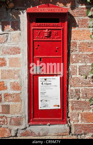 A Victorian Pillar Box in a brick wall in the English country village of Little Wittenham, Oxfordshire. Stock Photo