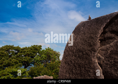 Pyramid of stones on huge rock on Similan islands Thailand Stock Photo