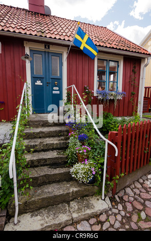 A typical swedish residential house, painted in traditional falun red, at Besvärsgatan in Oskarshamn. Stock Photo