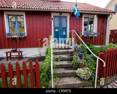 A typical swedish residential house, painted in traditional falun red, at Besvärsgatan in Oskarshamn. Stock Photo