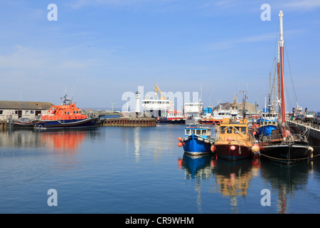 Fishing boats moored in inner harbour with the lifeboat and ferry beyond in Kirkwall, Mainland, Orkney Islands, Scotland, UK Stock Photo