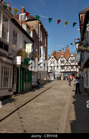 Old traditional terraced shop fronts and buildings on cobbled street, Steep Hill, Lincoln, Lincolnshire, England, UK Stock Photo