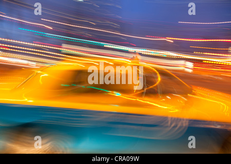 Taxi cab blured in motion on night city street Stock Photo