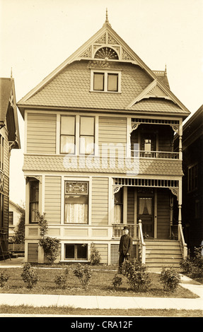 Young Man in front of Victorian Town Residence Stock Photo