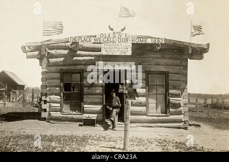 Expatriate British Man at Crude Oklahoma Log Cabin Stock Photo