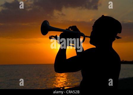 Man playing the trumpet at sunset, silhouette, Trinidad, Cuba, Caribbean Stock Photo