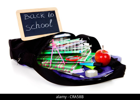 back to school: blackboard slate on bag with books with apple over white background Stock Photo