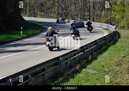 Motorcyclists in a curve on a country road with guard rail for protection, Eifel, Germany, Europe Stock Photo