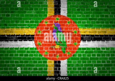 An image of the Dominica flag painted on a brick wall in an urban location Stock Photo