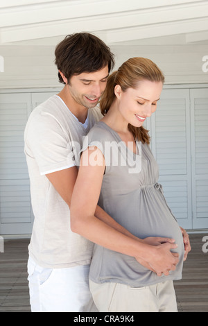 Man holding pregnant girlfriends belly Stock Photo