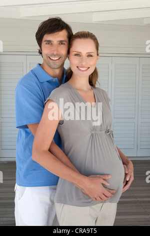 Man holding pregnant girlfriends belly Stock Photo