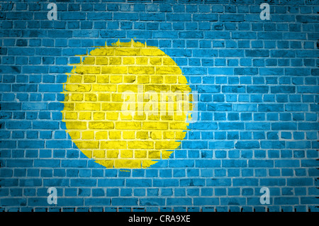 An image of the Palau flag painted on a brick wall in an urban location Stock Photo