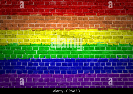 An image of the Rainbow flag painted on a brick wall in an urban location Stock Photo