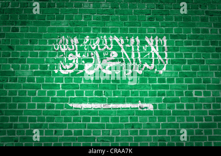 An image of the Saudi Arabia flag painted on a brick wall in an urban location Stock Photo