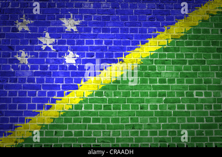 An image of the Solomon Islands flag painted on a brick wall in an urban location Stock Photo
