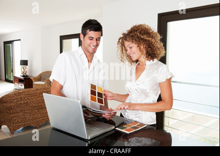 Couple examining swatches in home Stock Photo