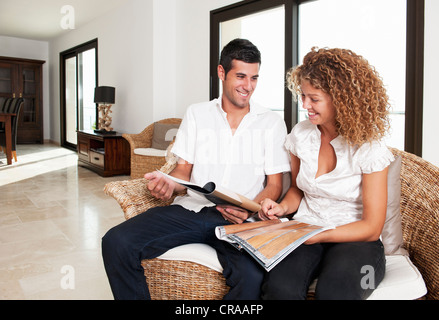 Couple examining swatches in home Stock Photo