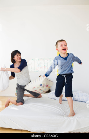 Mother and son having pillow fight Stock Photo