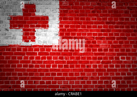 An image of the Tonga flag painted on a brick wall in an urban location Stock Photo