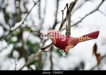 Close up of decorative bird in tree Stock Photo