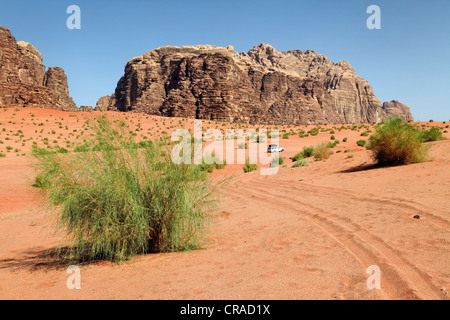 Mountains, vast plains, desert shrubs and an off-road vehicle, Wadi Rum, Hashemite Kingdom of Jordan, Middle East, Asia Stock Photo