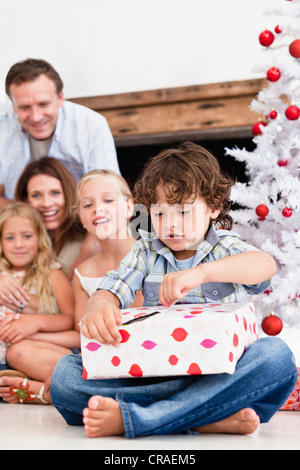 Boy opening Christmas gift Stock Photo