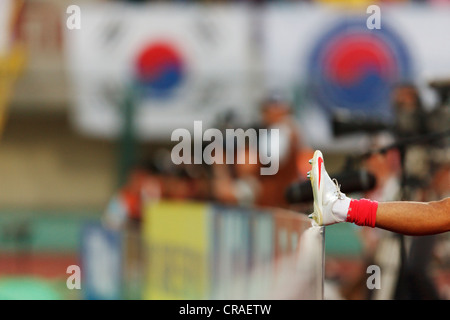 SUEZ, EGYPT - SEPTEMBER 29:  A substitute South Korean player places his foot on an advertising board to warm up during the FIFA U-20 World Cup Group C match against Germany at Mubarak Stadium on September 29, 2009 in Suez, Egypt. Editorial use only. Commercial use prohibited. (Photograph by Jonathan Paul Larsen / Diadem Images) Stock Photo