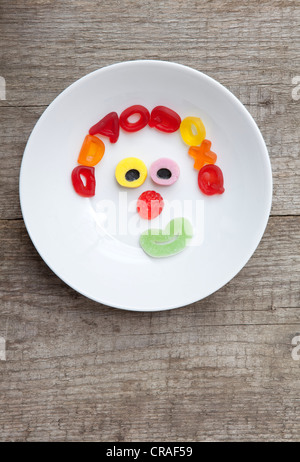 Face made of gummy bears, food for children Stock Photo