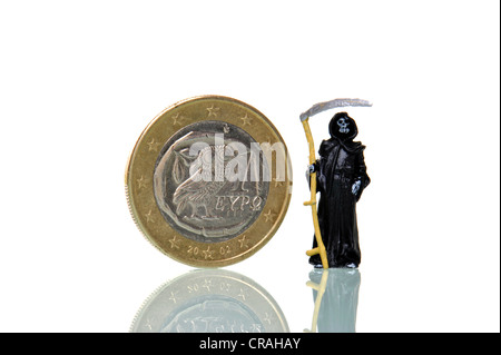 Death standing next to a Euro coin from Greece, symbolic image for Euro crisis Stock Photo