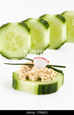 Cucumber topped with Houmus Stock Photo