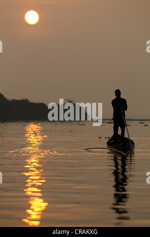Fisherman on Lake Vembanad at sunrise, Kerala, South India, India, Asia Stock Photo