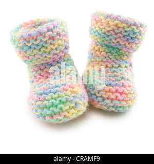 Hand knitted baby booties in multi coloured yarn, on white background, with clipping path. Stock Photo