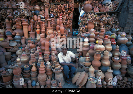 Boy sitting in front of a pottery shop, Jaipur, Rajasthan, northern India, India, Asia Stock Photo