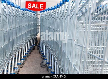 Supermarket shopping carts with SALE text label on a background Stock Photo