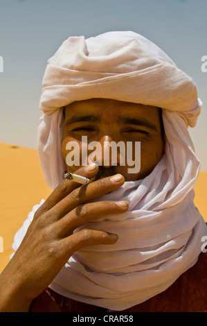 Smoking Tuareg man, portrait, in the Sahara, Algeria, Africa Stock Photo