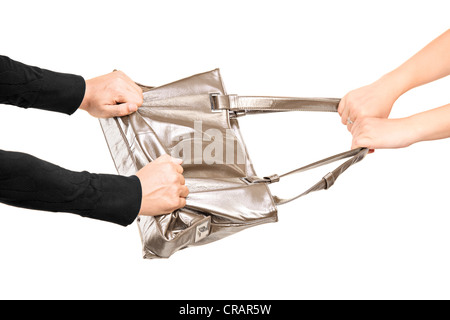 A thief trying to steal a handbag from a girl isolated on white background Stock Photo