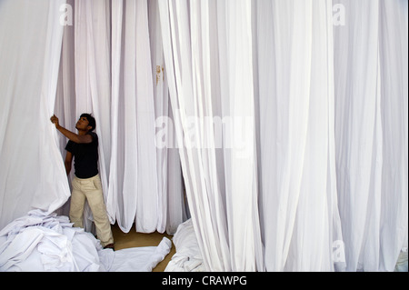 Man in front of white-coloured fabric, Sanganer dyeing centre near Jaipur, Rajasthan, India, Asia Stock Photo