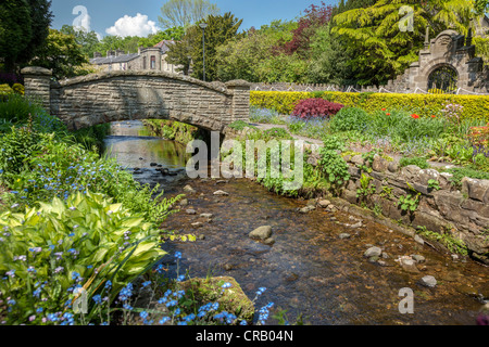The Coronation gardens in the village of Waddington in Lancashire with the stream that runs through the centre of the village. Stock Photo