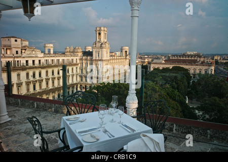 Rooftop pool and restaurant at luxury Parque Central Hotel in Old Havana, with the Palacio Asturiano on the background Stock Photo