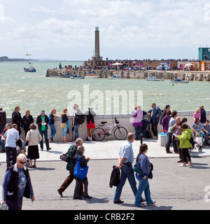 Crowds enjoying a windy but sunny day on Margate seafront.  Kent England Stock Photo