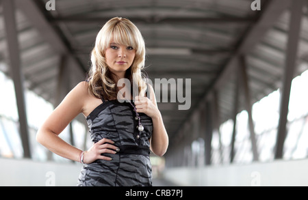 Young blonde woman posing confidently Stock Photo
