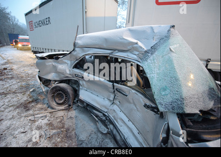 Fatal car accident on the slippery snow of an icy road, an E-Class Mercedes was hurled onto the opposite carriageway and Stock Photo