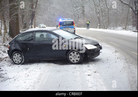 Small car after skidding on a slope in the snow on the Mittleren Filderstrasse road heading towards Plieningen, Stuttgart Stock Photo