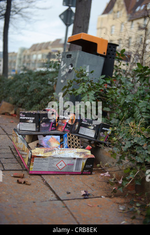 Packaging from fireworks lying in front of a trash can on the sidewalk, Stuttgart, Baden-Wuerttemberg, Germany, Europe Stock Photo