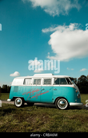 VW camper van, hippie bus, T1, 1960's, original turqouise and white colour, white wall tyres, elevating roof and inscription Stock Photo
