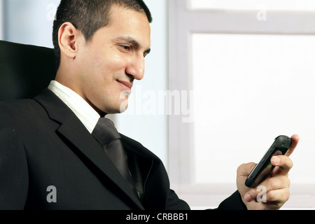 Business man reading message on cell phone Stock Photo