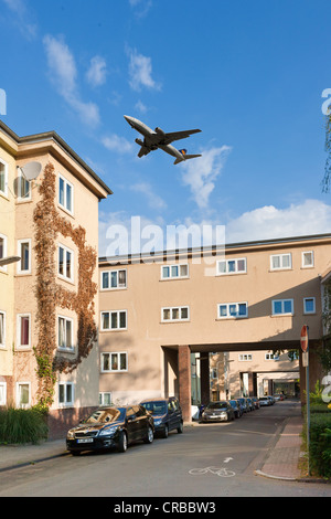 Aircraft flying over residential buildings, aircraft noise in residential areas, digital composing, Frankfurt, Hesse Stock Photo